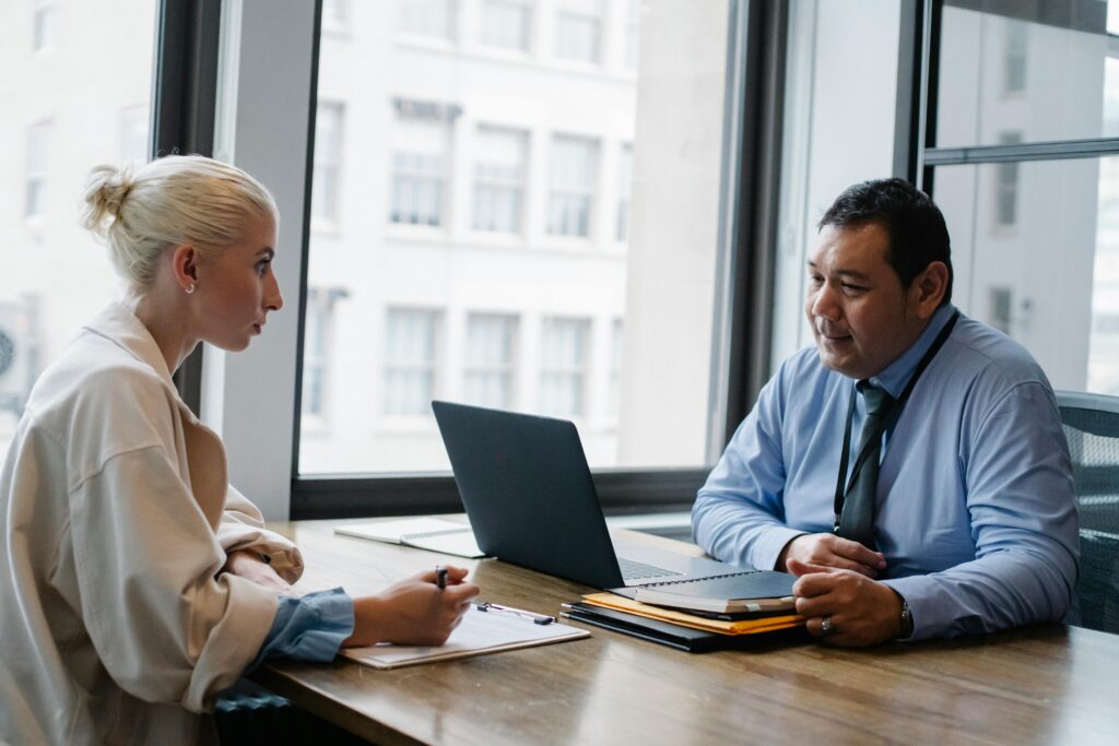 pexels-photo-5668863-5668863 Two professionals engaged in a job interview discussion in a modern office setting.